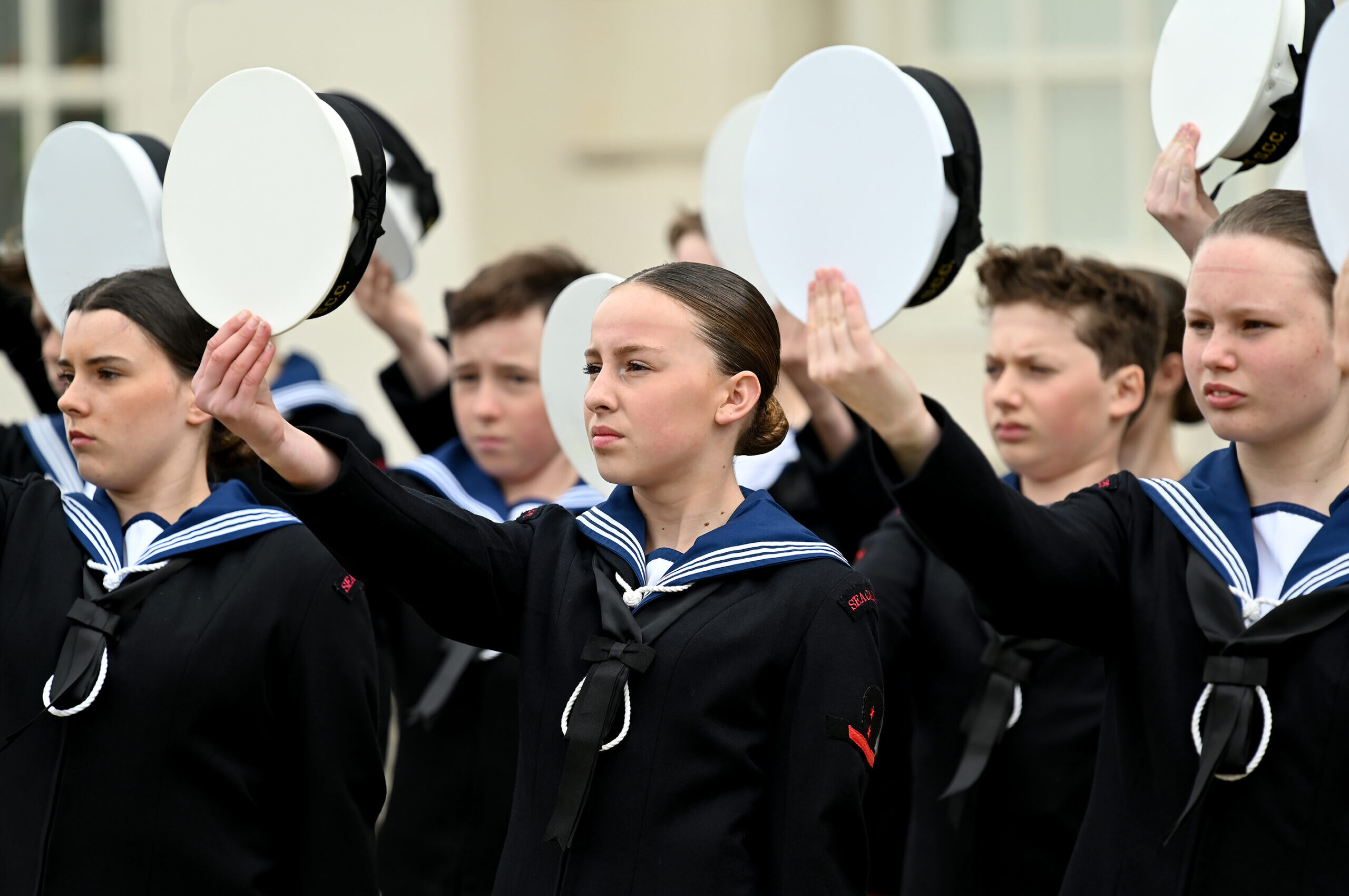 Sea Cadets holding their hats as a sign of respect for the king